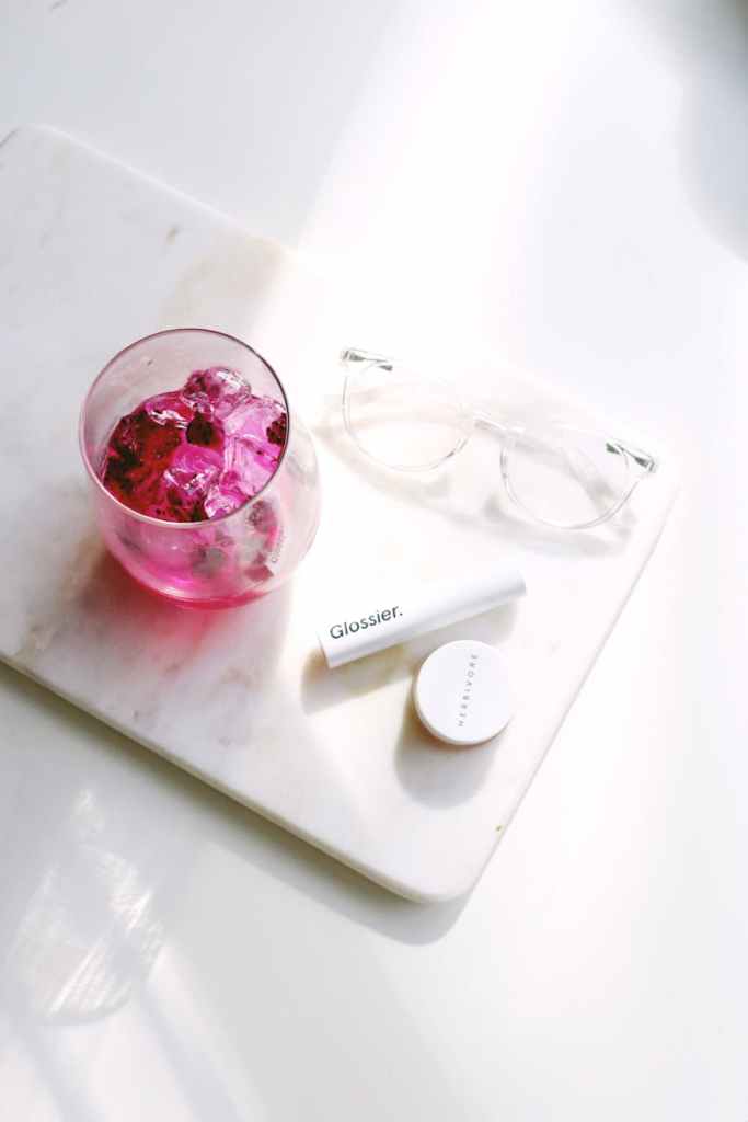 cup beside eyeglasses